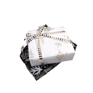 Papier cadeau élégant avec dorure à l'or pour Noël et anniversaires avec rubans