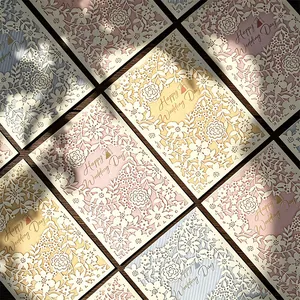 Macro view of French laser-cut wedding cards with elegant floral patterns
