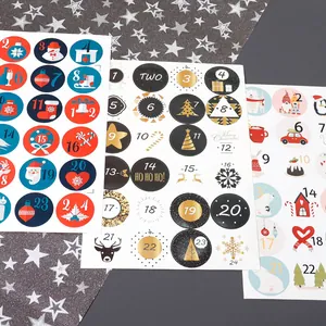 Detailed view of three Christmas advent calendar sticker sheets with numbers 1-24