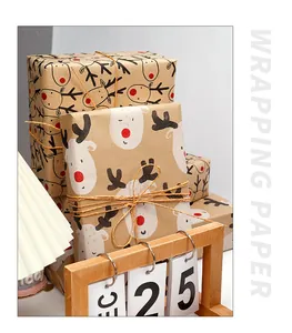 Christmas kraft wrapping paper with reindeer print, styled with holiday desk decorations