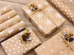 Close-up of vintage kraft Christmas wrapping paper featuring white snowflake patterns