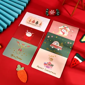High-angle view of premium Christmas cards featuring gold foil lettering and festive illustrations