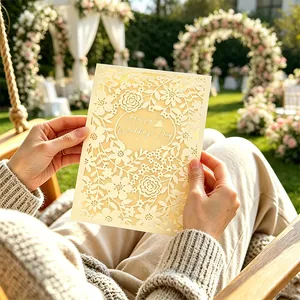 Close-up of intricate French laser-cut wedding invitation with Happy Wedding Day text