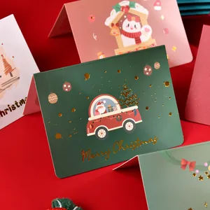 Detailed view of dark green Christmas card with gold foil Merry Christmas text