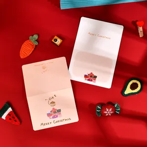 Detailed view of elegant gold-stamped Merry Christmas greeting cards on red background