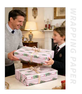 Festive Christmas wrapping paper featuring pink stripes and holiday motifs in a home setting.