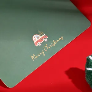 Close-up of vintage green Christmas card with gold foil Merry Christmas text
