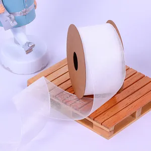 Detailed view of white semi-transparent organza ribbon showing its delicate woven texture