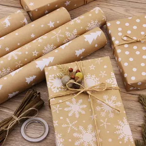 Vintage Christmas kraft wrapping paper rolls with snowflake and pine tree patterns