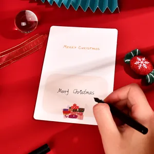 Close-up of a Christmas greeting card with elegant handwritten Merry Christmas text