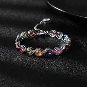 Detailed view of an elegant silver-tone bracelet featuring multi-color teardrop zircons