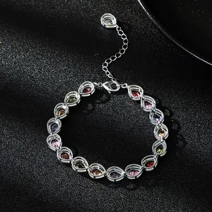 Detail shot of elegant silver bracelet featuring vibrant multi-color teardrop zircons