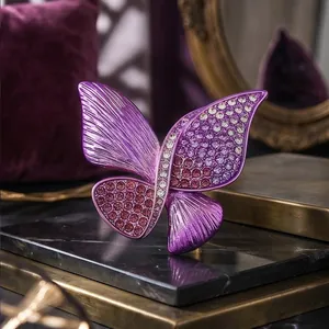Elegant purple butterfly brooch encrusted with shimmering rhinestones for luxury suit decor.