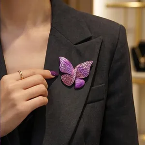 Luxurious purple butterfly brooch with crystals pinned on an elegant dark gray blazer
