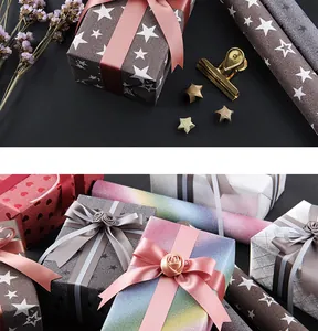Detailed view of iridescent glitter gift wrapping paper with star and heart patterns.