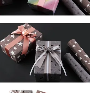 Detail of sparkling gift wrapping paper with star patterns and elegant ribbons.
