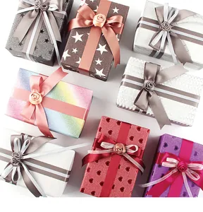 Macro view of assorted premium glitter gift wrapping paper with satin ribbons and roses