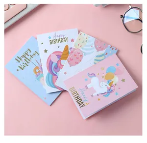 Cute unicorn themed foldable happy birthday greeting cards shown on a pink background.