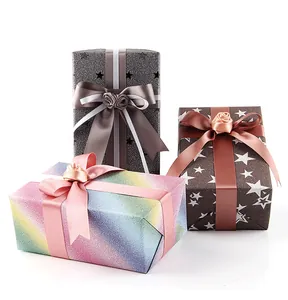 Close-up of premium glitter wrapping papers featuring star patterns and satin ribbon bows