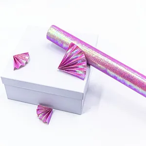 Iridescent purple glitter gift wrapping paper roll with a shimmering texture for packaging