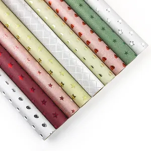 Mixed glitter wrapping paper rolls with star and heart patterns in various colors