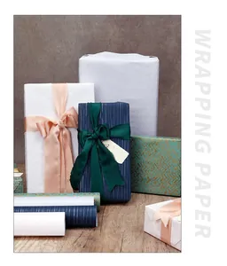 Variety of premium textured gift wrapping paper rolls and wrapped gift boxes in various colors