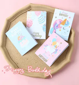 Detailed view of four cute pastel birthday cards with unicorn and cake designs