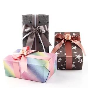 Elegant iridescent glitter wrapping paper gift boxes with rainbow and star patterns