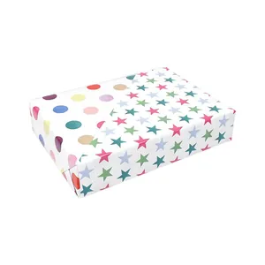 Detailed shot of double-sided copperplate gift wrapping paper with star and dot patterns
