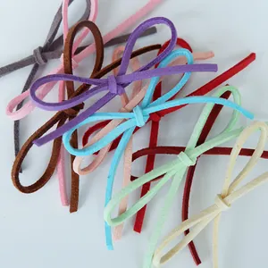 Macro view of various colorful Korean velvet ribbons tied into bows for gift wrapping