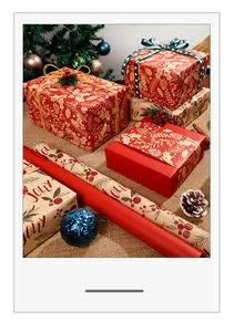 Detailed view of festive red and brown kraft Christmas wrapping paper on gift boxes