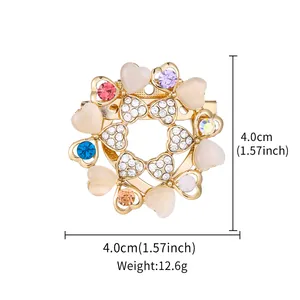 Detailed macro view of heart-shaped brooch with multicolor rhinestones and 4.0cm size markers