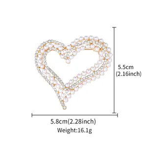 Detail of heart-shaped pearl and rhinestone brooch showing 5.8cm width and 16.1g weight