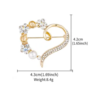 Detailed view of heart-shaped brooch with pearls and rhinestones showing dimensions