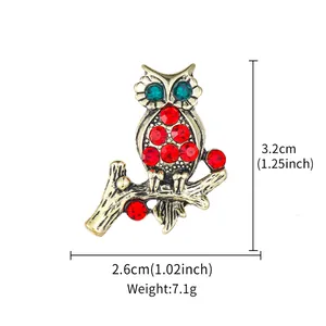 Detailed view of vintage owl brooch with red and green crystals and dimensions