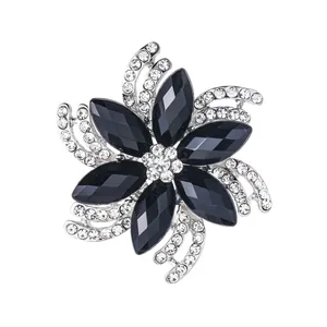Elegant flower brooch with black stones and sparkling rhinestones on silver base