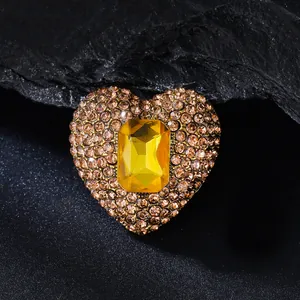 Close-up of heart-shaped brooch with amber crystals and yellow gemstone