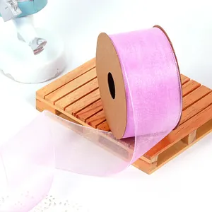Close-up detail of pink translucent snow ribbon roll for gift wrapping and DIY bows