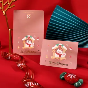 Elegant pink Christmas greeting card featuring gold foil text and cute snowman motif