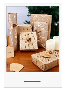 Primo piano di carta da regalo kraft natalizia con motivo HO HO HO dorato e spago