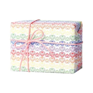 Rainbow heart pattern gift wrapping paper with pink string bow for party or birthday