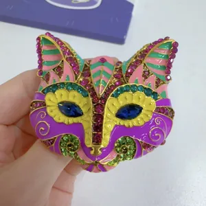 Detail of a vintage colorful cat head brooch with enamel and vibrant rhinestones