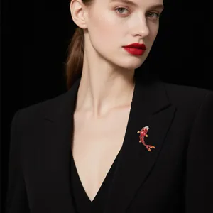 Detailed view of an elegant red koi fish brooch with enamel finish on a black blazer