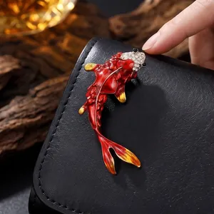 Elegant red koi fish brooch with crystal encrusted head and golden fins detail