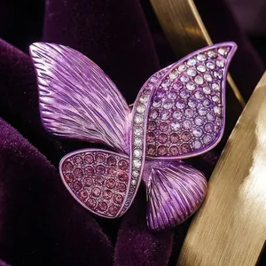 Luxurious purple butterfly brooch with gradient crystals on deep velvet background