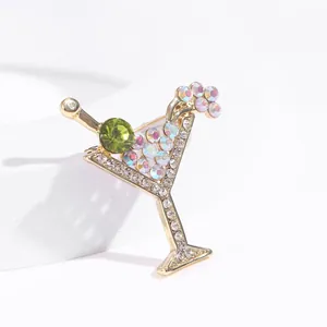 Close-up detail of a vintage gold cocktail glass brooch with sparkling rhinestones