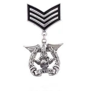 Vintage military-style metal brooch featuring eagle crest and CATEN banner detail