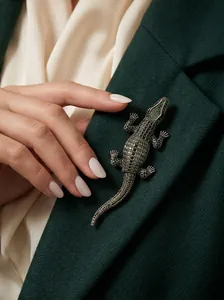 Detailed macro shot of an exquisite sparkling green crystal crocodile animal brooch pin