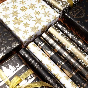 Papel de regalo premium negro y dorado con motivos de renos y copos de nieve