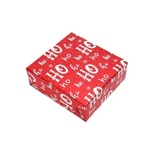 Red Christmas gift wrap paper with white HO HO HO lettering and snowflake pattern